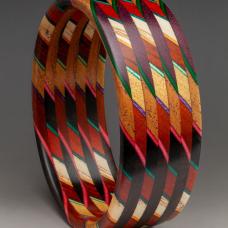 Part of the &amp;quot;Unbound&amp;quot; Series  the laminate is cut on a 45 degree angle and then the slices are stacked and orientated in a 90 degree rotation. The exotic and domestic hardwoods are sustainably sourced throughout the world  accented with dyed Maple veneer. 225 individual pieces