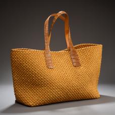 This tote was handcrafted from individually hand-cut  edge-thinned  edge-dyed  and folded 3/16-inch bison leather strips which were hand-braided into three-thong cords then used as strips to weave the bag the traditional way using basic weaving pattern. Provided with alligator leather handles.