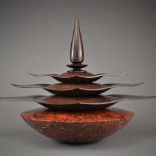 The Wenge finial lid fits upon three flowing hollowed out Wenge diamond boxes receding in size perfectly fitted to stack upon each other  which fit and set upon the large hollowed out Jarrah Burl storage vessel (base). Innovatively sculpted on the lathe at over 2000 rpm.