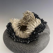 Hollow porcelain vessel carved with crosses and topped with clusters of anenome-like tenticles and mussel shells