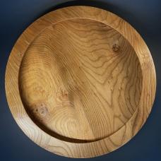 A huge slab of Elm is hard to find. This surface could be plain and simple. But by giving the platter an unusual undercut rim the grain is accentuated and interest is heightened overall. Can be hung or placed on a large table.
