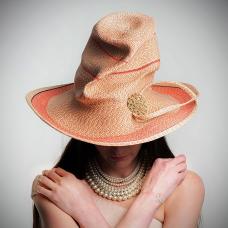 This piece is stitched from a very narrow Swiss braid  of synthetic/rayon mix fibers. With some hemp and horsehair layered along parts. I started at the center of crown  shaping as I stitch. The loop at the brim edge is done as finish last few strands. Creases and folds done as last step.