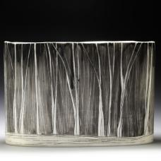 porcelain vessel with black linework resembling abstract trees.