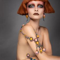 Cantaloupe is a playful jewelry set composed of a necklace with magnetic closure  earrings and a bracelet with magnetic closure. Repurposed dimpled resin spheres from 1960 are nestled in the bead mesh  as if they were precious gems. Title is inspired by the beads' color.