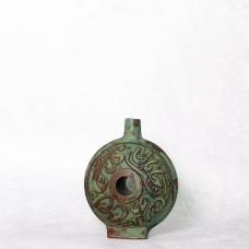 greena and brown vase with center hole and inscription