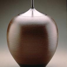 Thrown dark brown shiny terracotta vase with black accents.