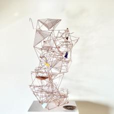 freestanding copper wire kinetic sculpture. Steel marbles can be dropped into the top of the sculpture to see them race down the sculpture on two separate tracks interacting with five moving elements with enamel counterweights.