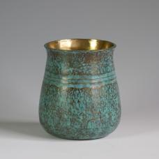 This brass vase is hammered out of a thick plate of 1/8&amp;quot; brass  stretched and then raised into a volumetric form.