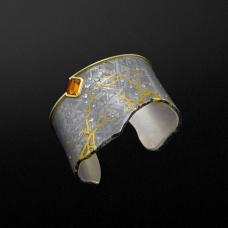 Cuff Bracelet in Gibeon Meteorite with 24k gold inlay  18k gold  sterling silver  (60) VS 1 ideal-cut RBC white diamonds (.79 tcw)  and a 3.12 ct emerald-cut very fine orange sapphire. Fabricated  forged  inlayed  and etched.