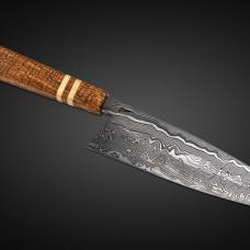 My seven inch chef's knife  the Damascus I diffusion bonded from 26C3 and 15N20 steels  and I made the handle from Curly Javanese Mango  with American Holly Accents.