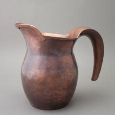 Hand raised copper pitcher with hollow handle and cut-card decoration