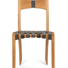 White oak dining chair with bridle joints on front legs. Back has a bandsaw carved detail that has been accented with gray paint. Seat woven with gray leather straps for a comfy sit.