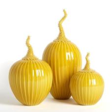 Three yellow pumkin shaped sculptures with spikey upwards-reaching stems