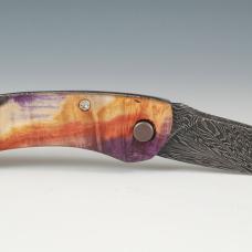 House made Damascus Steel tool steel forged and fabricated into a wonderfully functional folding knife. Handle is made of dyed and stabilized box elder burl.