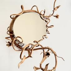 Smokey Mirror framed by a steam bent sassafras vine that undulates with leaves and buds.