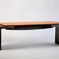 Ebonized solid walnut base with a sculpted and bowed stretcher supporting a floating seat made of solid figured bubinga.