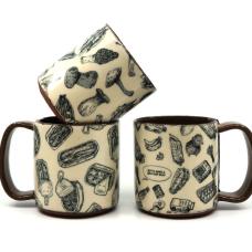 Three mugs, one with illustrations of mushrooms, one with illustrations of canned fish, and one with illustrations of various groceries.