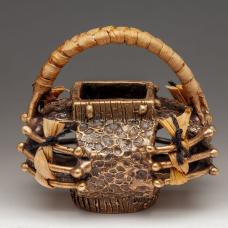 Cast bronze basket with woven and twined sweet grass