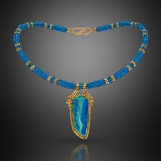 Collar  hand-woven with blue topaz and 18k gold beads. Pendant  hand fabricated 18k gold bezel  surrounded by woven 18k beads  and set with an Australian opal.
