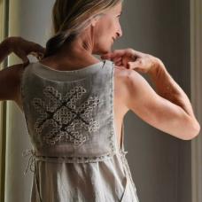 Tabard hand embroidered front and back with traditional ornament from Lyvani area in Latvia.