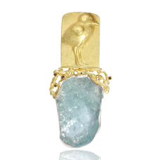 The gold repousse sandpiper is standing on fused textures beach with little diamonds  . The aquamarine representing water  I cut   is set in silver