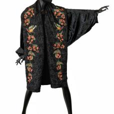 Cocoon coat constructed using mill end and vintage fabrics. Created to honor the ongoing struggle of women in Iran and Kurdistan. Embellished with custom embroidery and the resistance slogan Women - Life - Freedom written in English and Arabic calligraphy.