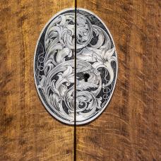 The nickel silver escutcheon plate is engraved with an acanthus and lily pattern.
