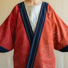 The jacket is hand-stitched on cotton fabric dyed with madder and indigo. The poem stitched on the piece signifies that each end exists solely because of a beginning. The fish bring the philosophical message to life by symbolizing the vivacious cycle of life on Earth.