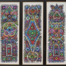 Three verticle rectangular framed pieces made up of colorful pieces connected and embellished with thread