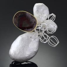 This brooch depicts a scenery of flower buddings growing through the rocks. I used a fancy quartz to indicate a rock  broken in half  showing it's colorful beauty inside. 22k gold  sterling silver  Quartz.