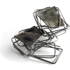 One of a Kind Brooch A chain is created with forged sterling silver rectangles. Together these links create a platform to set the black mica. The 3 dimensional configuration gives the illusion of stepping into ones place.