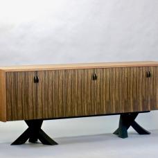 Sculptural ebonized walnut legs of intersecting tapered arcs support a case made of solid walnut featuring 3000 year old rift sawn bog oak doors and pulls.