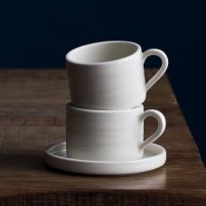 two stacked coffee cups with subtle line suggesting a hand-throwing process