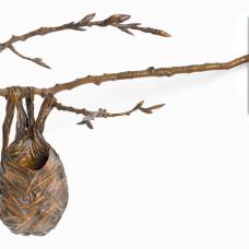 Cast bronze sculpture of a bird nest sagging off of a Cottonwood branch and a luminescent antique brown patina.