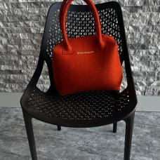 orange felt bag on a chair